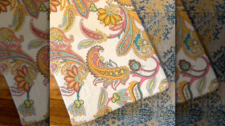 DIY floor pillow with paisley pattern sitting on hardwood floor and area rug