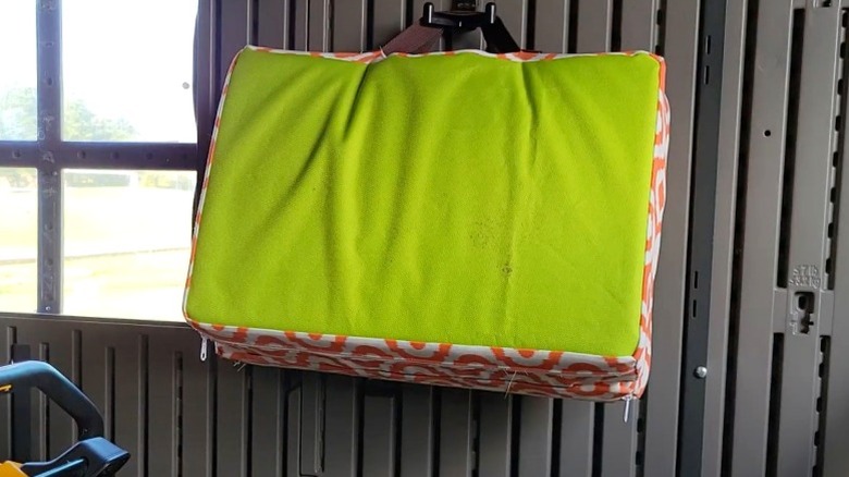 DIY foam garden kneeler hanging on wall in outdoor storage shed