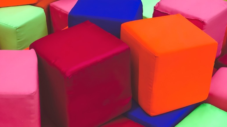 Pile of large foam cubes wrapped in colorful fabrics