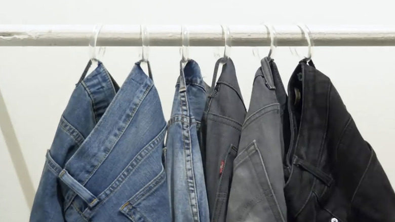 Jeans hanging from shower curtain rings