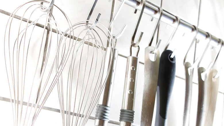 kitchen utensils hanging from rod