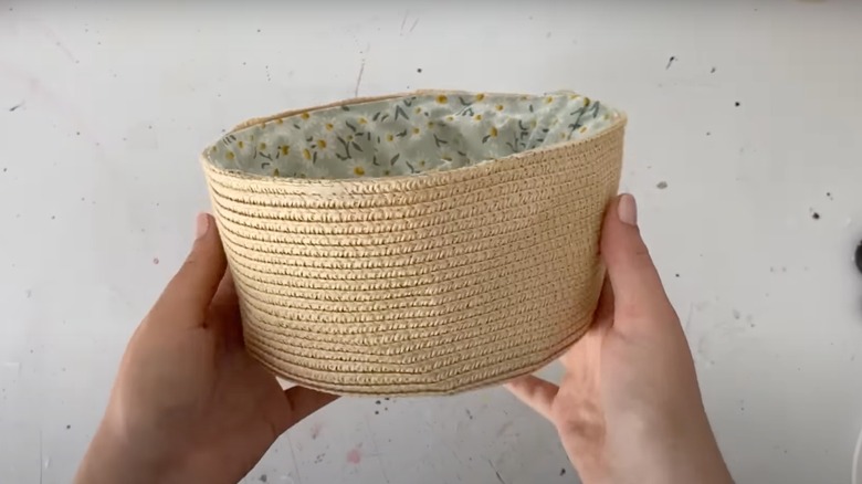 person holding straw basket