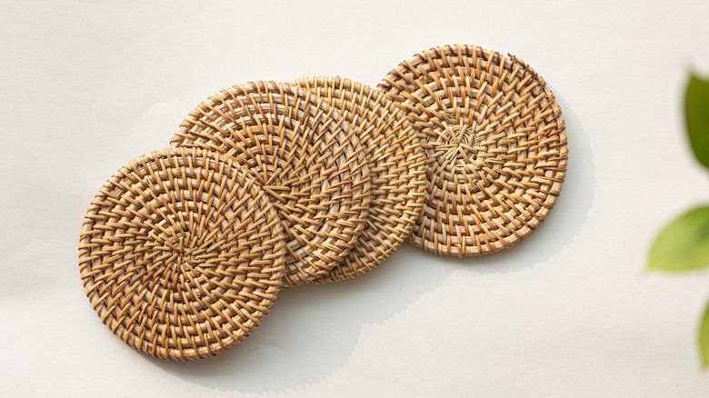 four rattan coasters on table