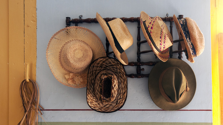 straw hats hanging on rack