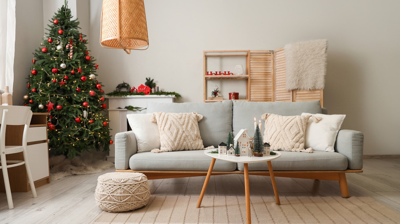 Candles burning in a living room decorated for the holidays