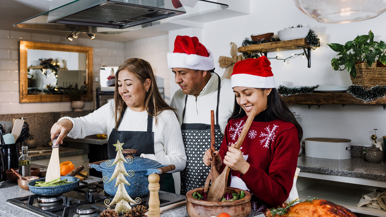 Family preparing holiday meal on Christmas