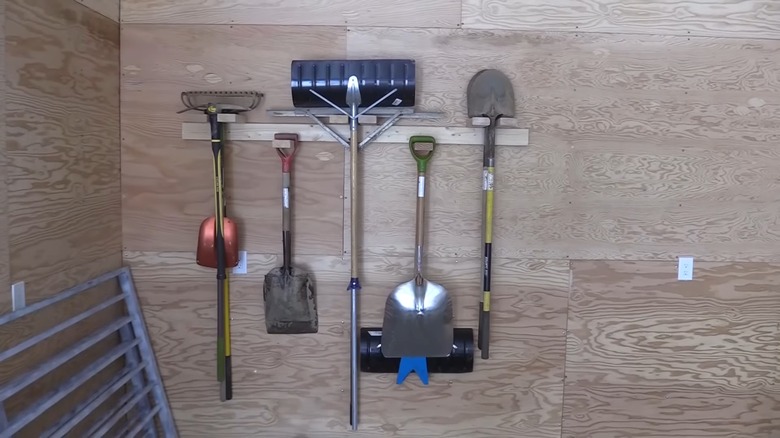 Gardening tools on wood panel