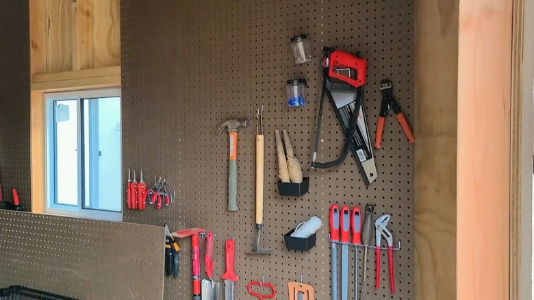 Gardening tools on pegboard