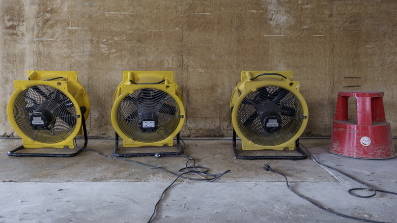 Three industrial dehumidifiers in an attic space