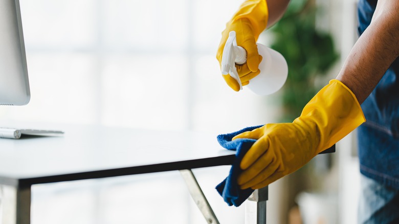 person cleaning a table