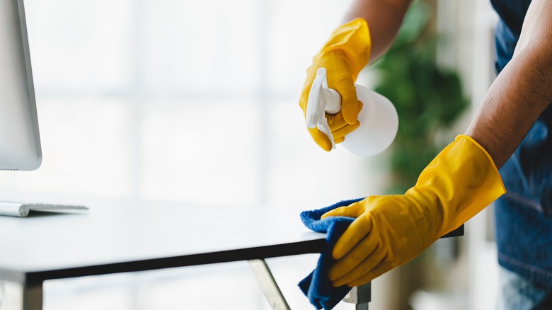 Person cleaning table