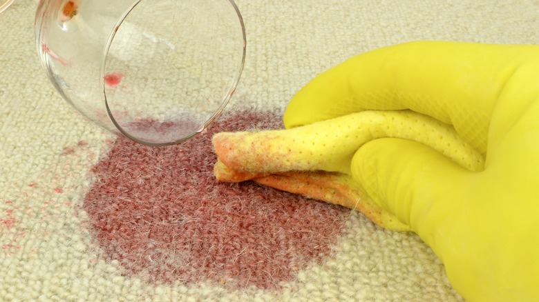 Person cleaning spilled red wine