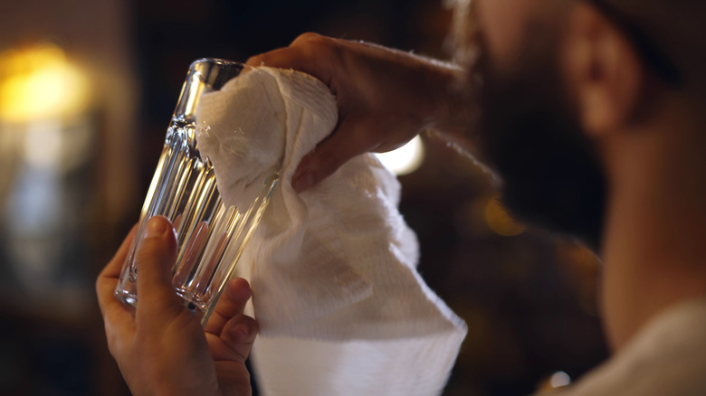 Person wiping glass