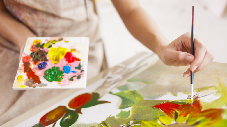 woman painting with black brush