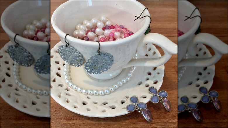 jewelry in white teacup holder