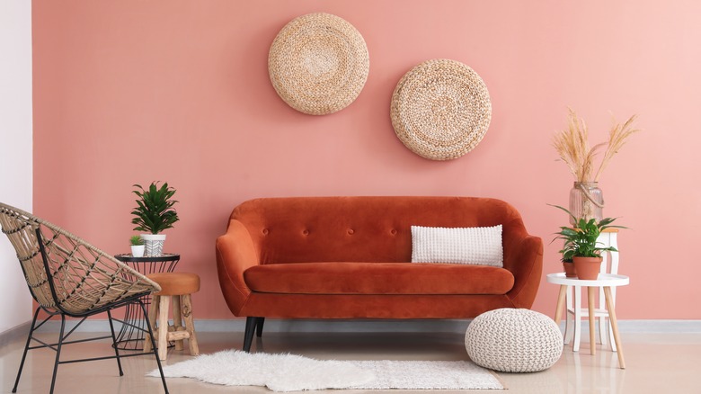 pink wall and orange couch