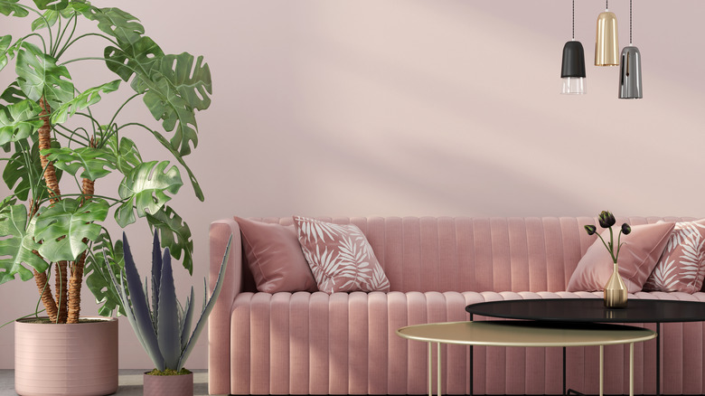 pink couch with gold accents