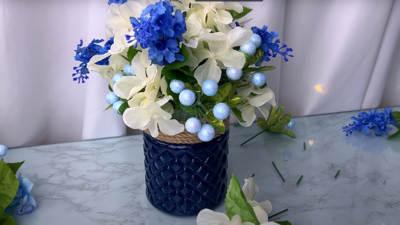 blue jar with flowers