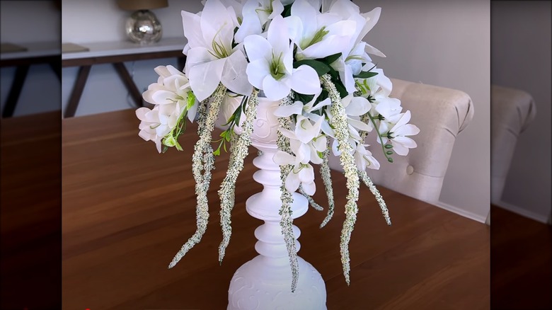 tall white centerpiece with flowers