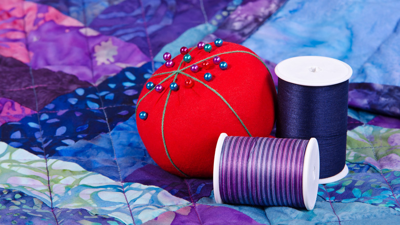 red pin cushion with thread