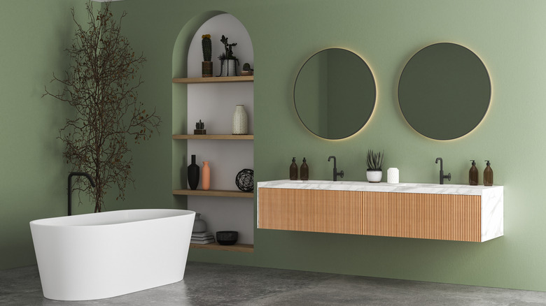 Sage green accent wall in bathroom