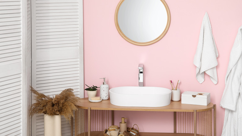 Bathroom with a pale pink accent wall