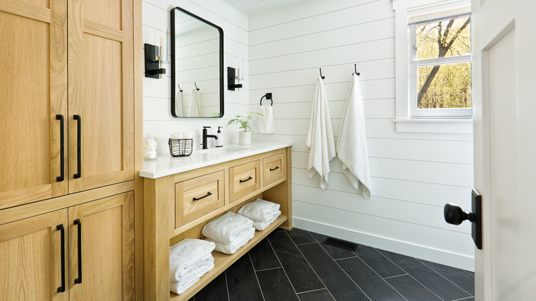 dark bathroom tiles installed diagonally