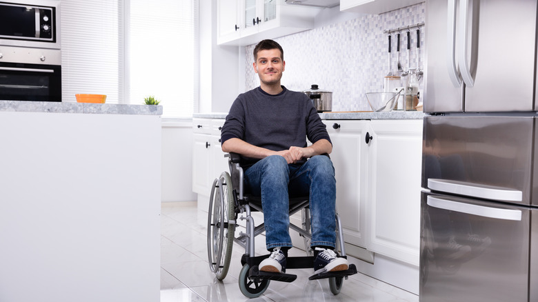 Disabled in wheelchair in kitchen