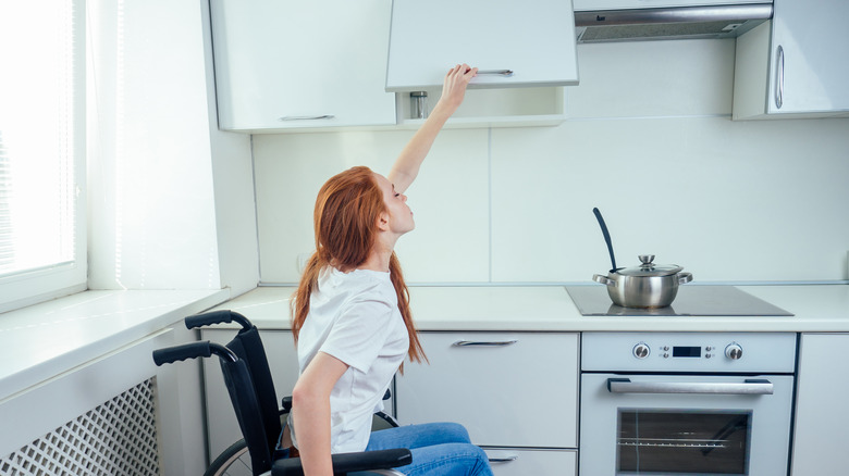 Person lifting cabinet door