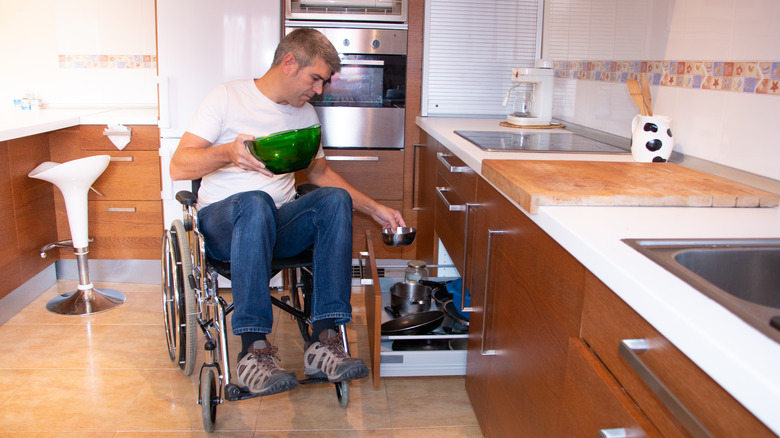 Person in wheelchair storing items