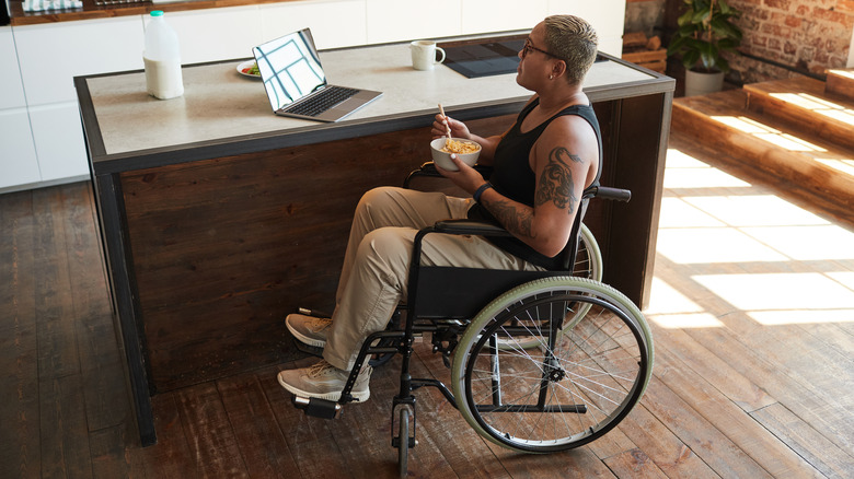 Person in wheelchair reading laptop