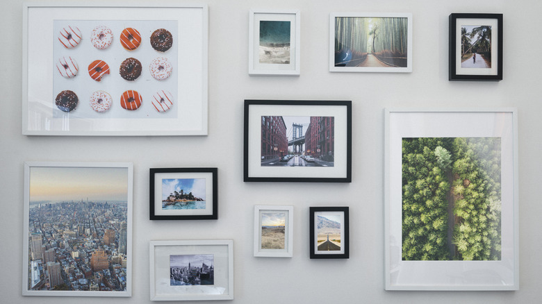 Gallery wall of cities and donuts on white wall