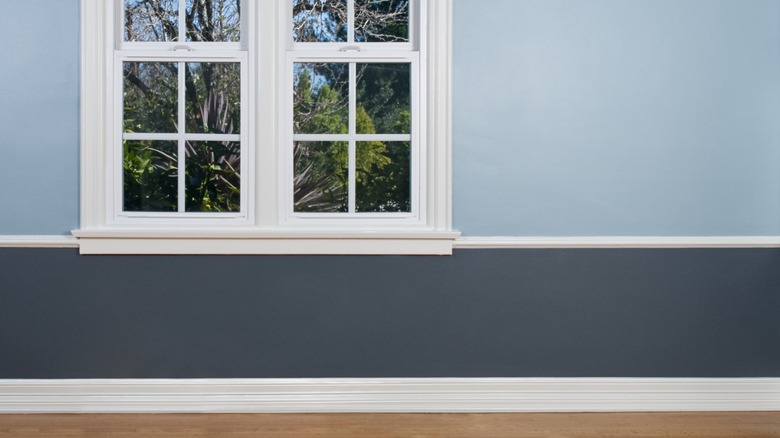 Two-toned wall with dark gray on the bottom and light blue on the top