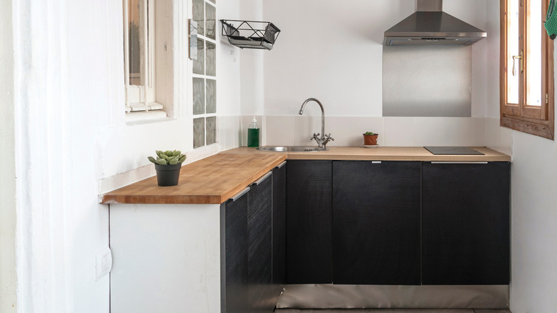 Small kitchen with black cabinets