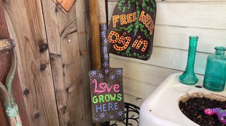 Two shovels with fun signs and designs on them