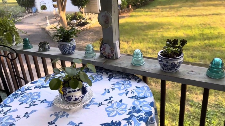 Decorative vases being used as planters along with other vintage garden decorations