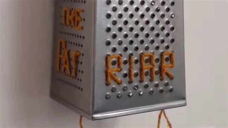 cheese grater with orange embroidery 