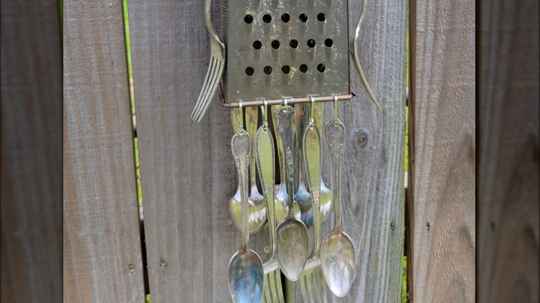 utensils dangling from cheese grater