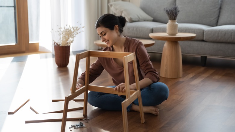 woman assembling furniture