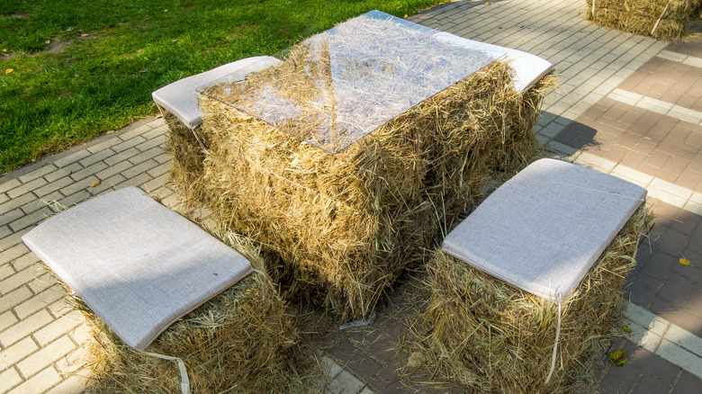 benches and a table from straw bales