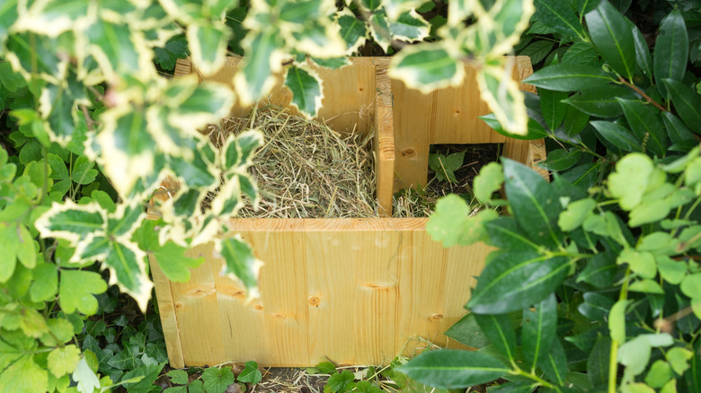 straw-stuffed hog shelter in garden