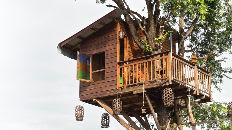 wooden treehouse with railing 
