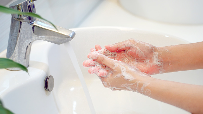 washing hands in sink