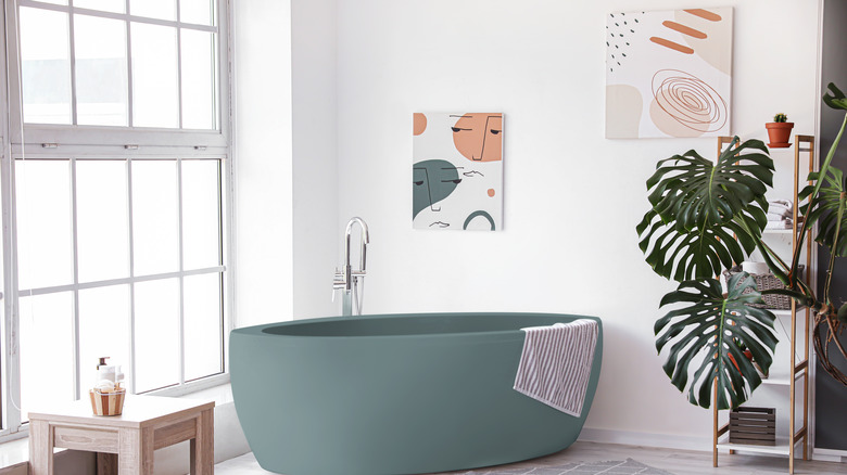 blue bathtub with abstract artwork