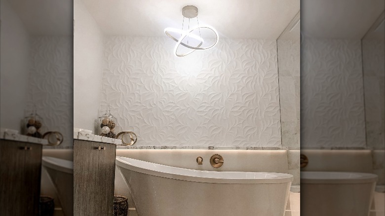 modern light fixture above bathtub