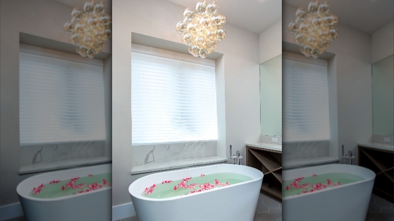 unique chandelier above bathtub