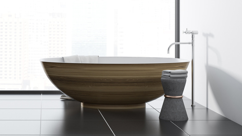 wooden bathtub and metal tap