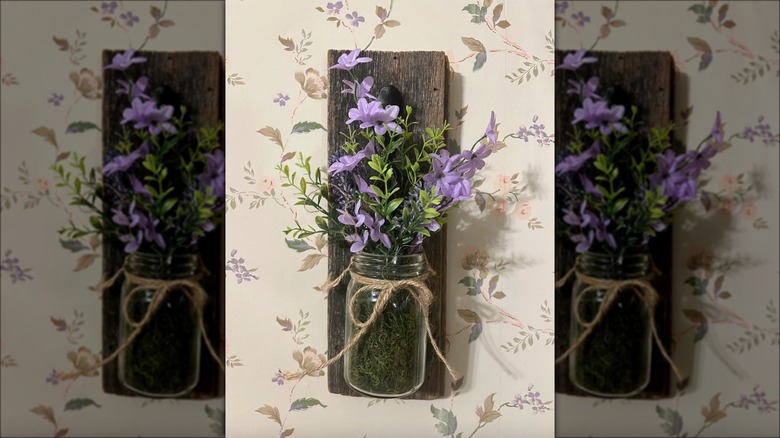 purple flowers in wall vase