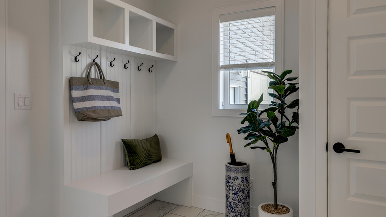 white mudroom bench with hooks