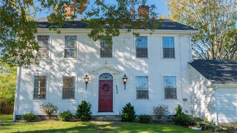 White colonial house, red door